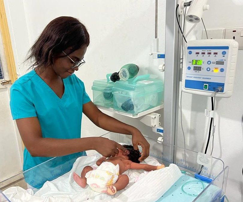 Gift, a Registered Nurse in Kumasi, Ghana caring for baby Akosua